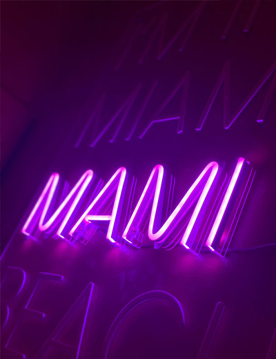 Purple neon MAMI sign on the restaurant wall